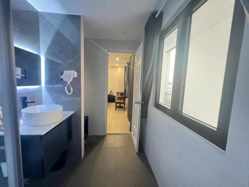a bathroom with a sink and a mirror at G Hotel Sai Gon in Ho Chi Minh City