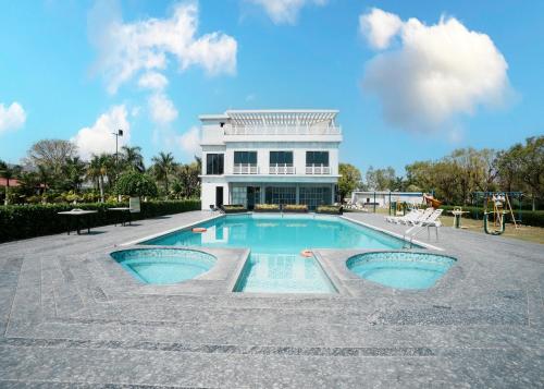 a swimming pool in front of a building at Rupis Resort in Dabok