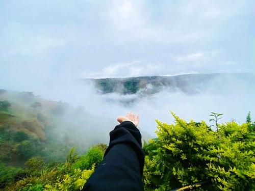 a persons leg sticking out from the top of a mountain at Fable Villa by Hill Staytion in Mahabaleshwar