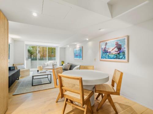 a living room with a white table and chairs at Bondi Pacific Studio - Managed by X Hospitality in Sydney