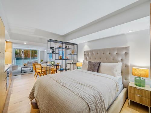 a bedroom with a large bed and a dining room at Bondi Pacific Studio - Managed by X Hospitality in Sydney
