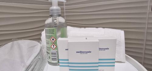 a bottle of disinfectant next to a box and a bottle of soap at HYDE PARK APARTMENTS in Čakovec