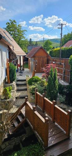 a wooden bridge in a yard with a house at Velem Spirit Apartment in Velem