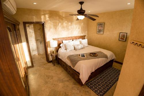 a bedroom with a bed and a ceiling fan at Beachside Bliss Studio, Walk to the Marina and Beach in Cabo San Lucas