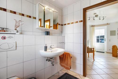 a bathroom with a sink and a mirror at Ferienhaus Krüger in Dörphof