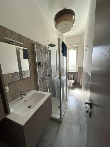 a bathroom with a sink and a shower and a mirror at Casa Franco in Turin