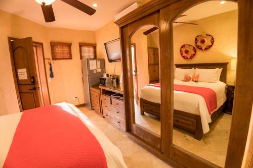 a bedroom with a bed and a large mirror at Prime Cabo Stylish Studio Near Beach and Marina in Cabo San Lucas