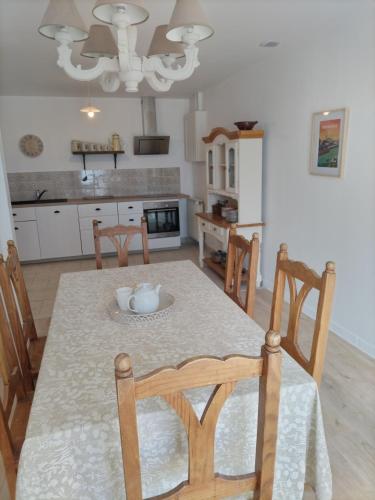 a kitchen with a table with chairs and a dining room at L'étude, gîte à la Coquille (Dordogne) pour 6 personnes in La Coquille