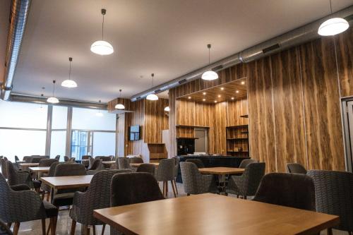 a conference room with tables and chairs and lights at HOTEL BAYKO in Plovdiv