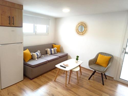 a living room with a couch and a table at Renovated Loft near the Center in Heraklio Town