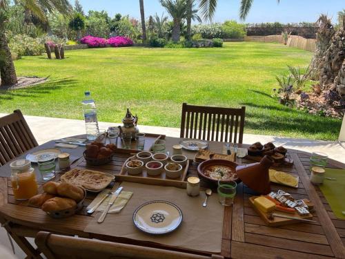 a wooden table with food on top of it at Villa Maria, Luxury Marrakech in Marrakesh