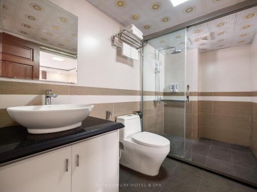 a bathroom with a toilet and a sink at Sapa Luxury hotel & Spa in Sa Pa