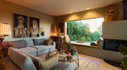 a living room with a couch and a large window at Luxurious Loft Living in Cape Town