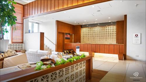 a lobby with a table with plants on it at Daiwa Roynet Hotel Naha Omoromachi in Naha