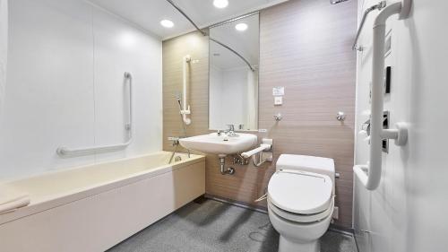 a bathroom with a toilet and a sink at Daiwa Roynet Hotel Naha Omoromachi in Naha