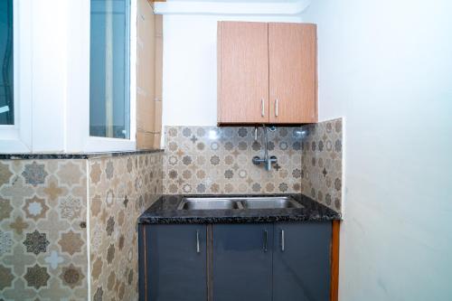 a kitchen with a sink and a counter top at Aster Studio Sec-39 Gurgaon I Fully furnished 2BHK in Gurgaon