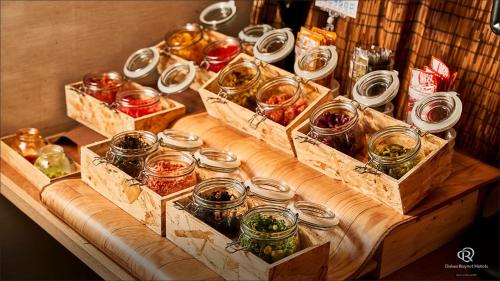 a table with jars of food on top of it at Daiwa Roynet Hotel Naha Omoromachi in Naha