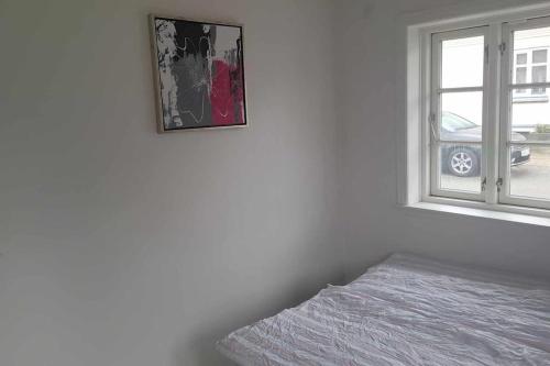 a bedroom with a bed next to a window at Marku House in Struer