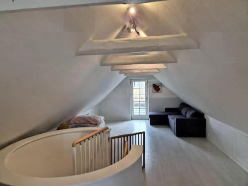 a attic room with a large tub in the middle at Marku House in Struer