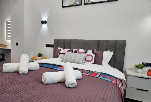 a bedroom with a large bed with pink and white pillows at ЖК Комфорт Сити Бизнес, 2 room Apartment 47 in Almaty