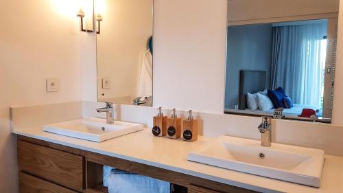 łazienka z 2 umywalkami i dużym lustrem w obiekcie Paradise Villa w mieście Grand Gaube
