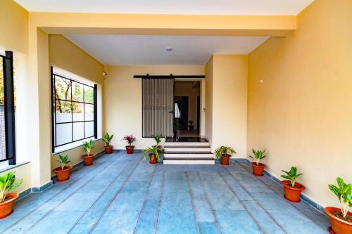 an empty room with potted plants in a building at IND57 in Siliguri