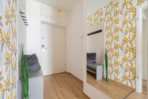 a room with a hallway with a mirror at WestSide Garden Apartments by FirstHost in Budapest