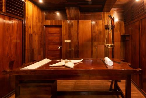 a wooden bath tub with towels on a table at ATREYA AYURVEDA BEACH RETREAT in Kovalam