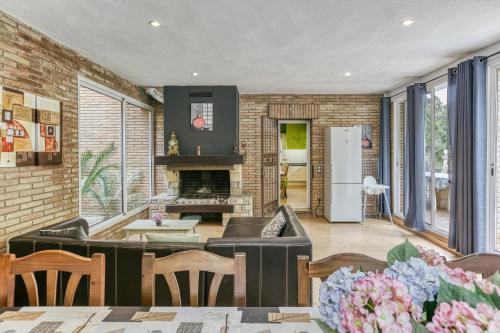 a living room with a couch and a fireplace at Casa Nadia in Romanyá de la Selva