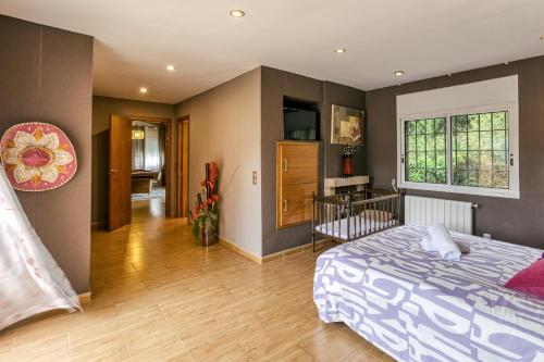 a bedroom with a bed and a living room at Casa Nadia in Romanyá de la Selva