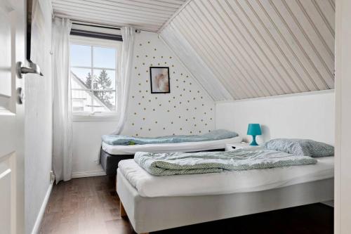 two beds in a small room with a window at Nice Villa near Lake! Free boat, sauna and big garden! 