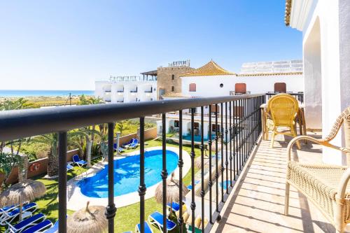 a balcony with a view of a swimming pool at Hotel Pozo del Duque in Zahara de los Atunes