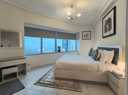 a bedroom with a bed and a large window at Trinity Holiday Homes - Sheikh Zayed Road Near to Financial Center Metro Station in Dubai