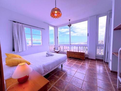 een slaapkamer met een bed en grote ramen bij Tropicalidays Puerto Brava 2 Double Rooms in Puerto de la Cruz