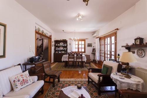a living room with a couch and a table at Zeusplace Magic Villa in Aigínion