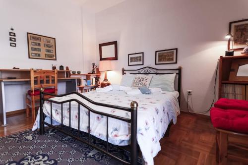 a bedroom with a bed and a red chair at Zeusplace Magic Villa in Aigínion