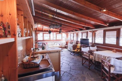 a kitchen with a table and a dining room at Zeusplace Magic Villa in Aigínion