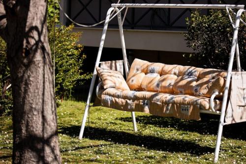 a couch sitting on a swing in the grass at Zeusplace Magic Villa in Aigínion