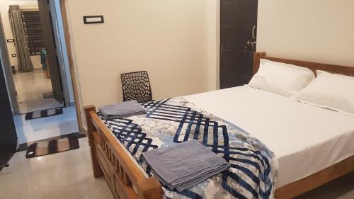 a bedroom with a bed with towels on it at Padmaa Hampi Echo Villa in Hampi