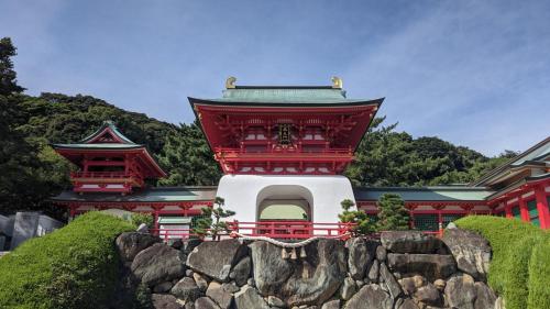 a red building with two towers on top of a stone wall at Toyoko Inn Shimonoseki Kaikyo yume tower Mae in Shimonoseki