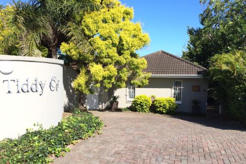 a house with a sign on a brick driveway at Pollock's B&B in East London