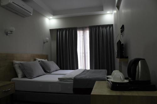 a bedroom with a bed with a window and a television at mojo otel in Konak