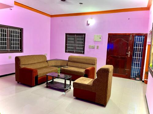 a living room with two couches and a table at COIMBATORE 2BHK AC Private Villa By Shivalaya -Kovaipudur- in Coimbatore