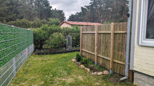 a fence in a yard next to a house at Haus zum Kiessee 