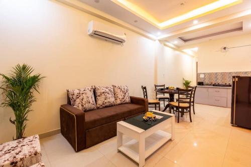 a living room with a couch and a table at Homlee-Vasundhara 5BHK with Terrace(For Function) in Ghaziabad