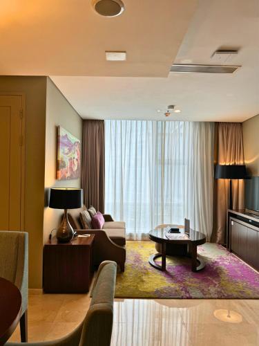 a living room with a couch and a table at Ascott Kuningan Jakarta in Jakarta