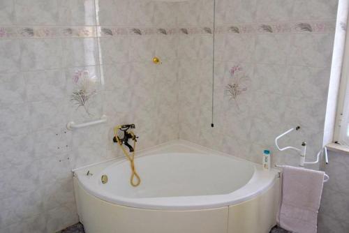 a white bath tub in a bathroom with a shower at Casa della Genovina in Capodimonte