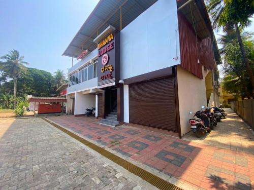 a building with a motorcycle parked in front of it at Dhanya Lodge in Padubidri