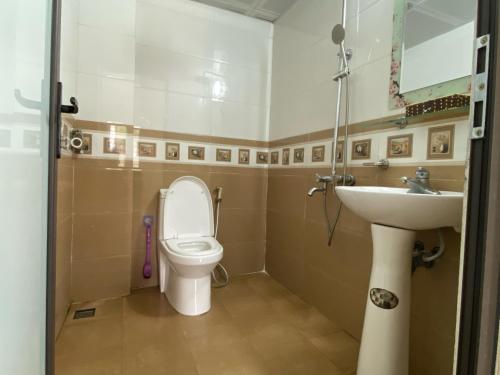 a bathroom with a toilet and a sink at Blue Rose Hotel in Ha Long