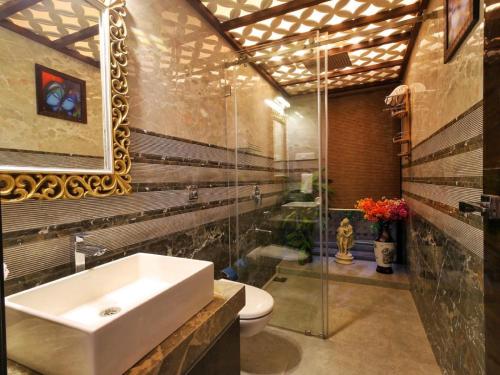 a bathroom with a sink and a toilet at Shore Beats Villa in Mumbai